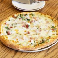 Prosciutto Provo Pizza · Garlic and olive oil, prosciutto, onion, spinach and provolone. All pizzas include sauce and...