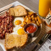 8. Award-Winning Scratch-Made Hash + Eggs Platter · From-scratch corned beef hash OR maple sausage-apple hash, two cage-free eggs any style, art...