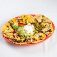 Nachos Haciendas · Topped with beans and cheese. Accompanied with guacamole, sour cream and jalapenos.