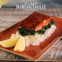 Jerk Salmon · Jamaican jerk marinated salmon served with white rice topped with fresh sauteed spinach and ...