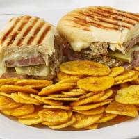 El Sandwich Cubano · This mouthwatering Cuban sandwich consists of pork, ham, Swiss cheese, pickles and mustard, ...