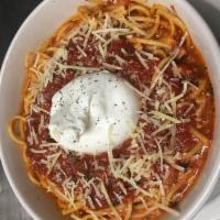 Pasta con Burrata · Spaghetti tossed in a light pomodoro sauce topped with a creamy ball of burrata and Parmesan...