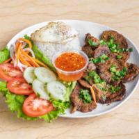 Com Thit Nuong · Char grilled pork served with rice and fried egg. Add an eggroll for an additional charge.