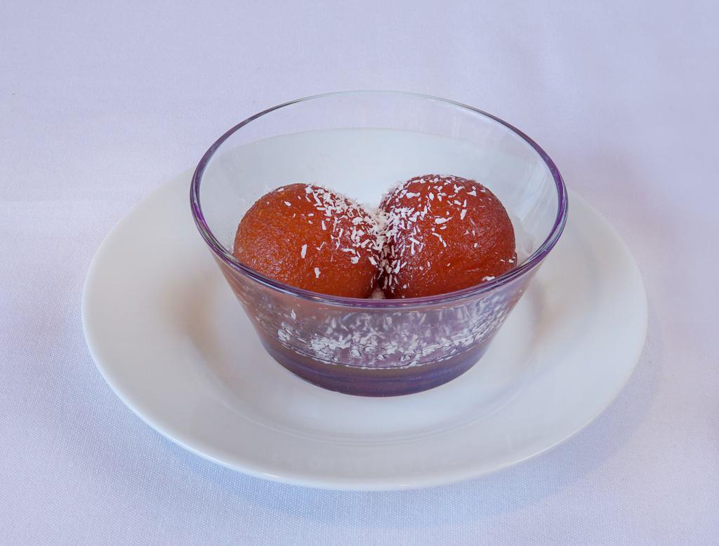 Gulab Jamun · Dumplings traditionally made from thickened and reduced milk soaked in rose flavored sugar syrup. Served warm.
