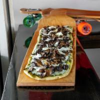 Shrooms Signature Pizza · Wild mixed mushrooms, roasted garlic, fresh mozzarella, basil pesto.