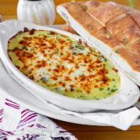 Spinach & Artichoke Dip · Our house recipe served with fresh baked bread bites, creamy and delicious.