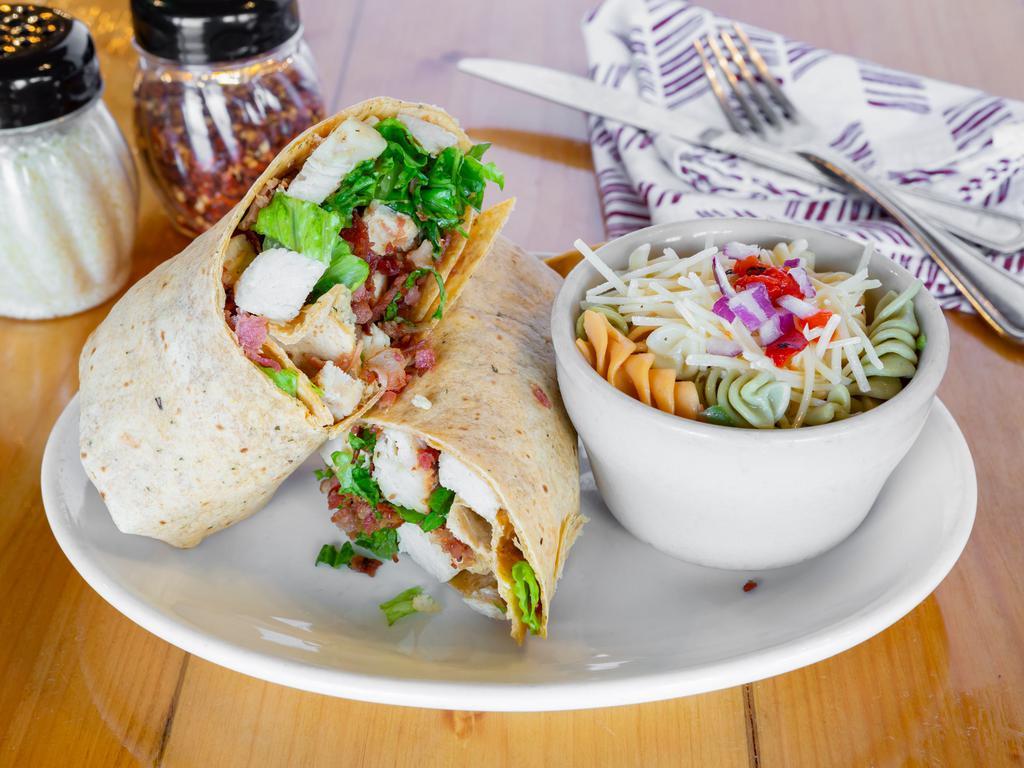 Chicken Caesar Wrap · Grilled chicken, romaine lettuce, shredded Parmesan rolled into a tomato basil wrap, and our famous Caesar dressing on the side.