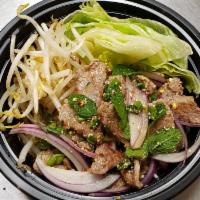 Num Tok Beef · Grilled steak and sliced mixed with mint, red onion, green onion, cilantro, chili, ground ri...