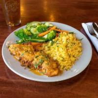 Potato Crusted Salmon Dinner · Pan-seared finished with a delicate roasted tomato cream sauce and served with rice and fres...