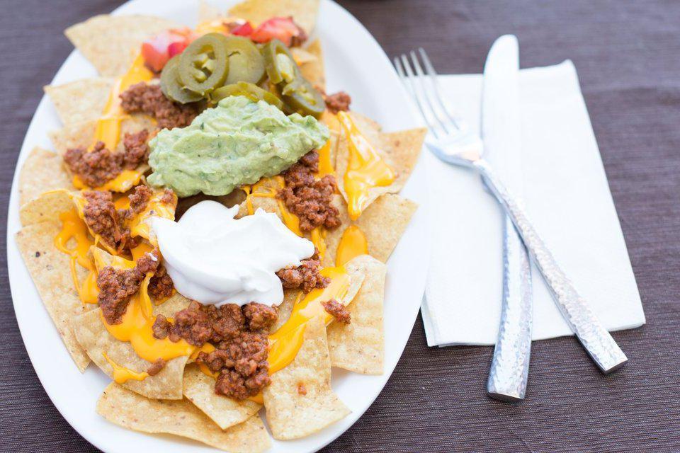 Super Nacho · Tortilla chips topped with your choice of meat, cheddar cheese, tomato, guacamole, sour cream and jalapeño peppers.

Pro Tip:  If you don’t like soggy tortillas chips, we ask you to order your nachos with the chips on the side