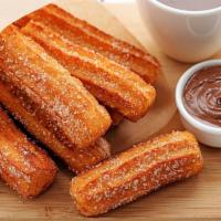 Churros* · 6 Mini churros served with our special heavy whipped cream and chocolate.