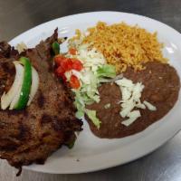Carne Asada Plate · Grill steak with onions, bell peppers, rice, beans and salad.