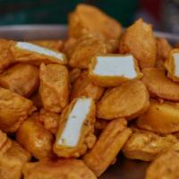 1A. Paneer Pakora · Homemade cheese battered and deep fried. Served with sliced onions and lemon.