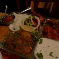 42. Tandoor A India Combo · 1/4 chicken tandoori, choice of curry, bengan bhartha, naan, rice, raita, and dessert.