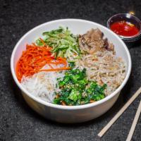 Bibimbap · Rice dish served with steamed carrots, daikon (radish), zucchini, shiitake mushrooms, spinac...