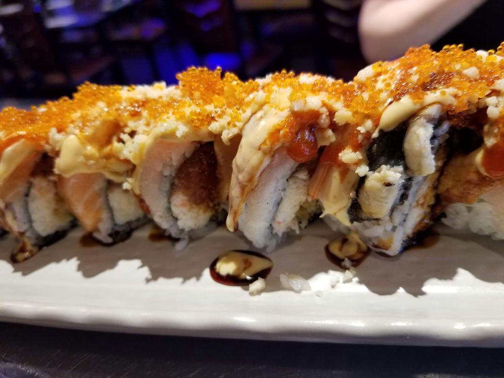 Kampai Dragon Roll · In: shrimp tempura, jalapeno and cream cheese. Out: eel, spicy tuna, green tobiko with eel sauce and spicy mayo.