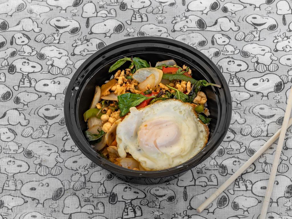 Pad Kra Pow Kai Dao · Grounded chicken stir-fried with basil, bell peppers, Thai chili, and garlic in brown sauce, topped with a fried egg, served with rice. 