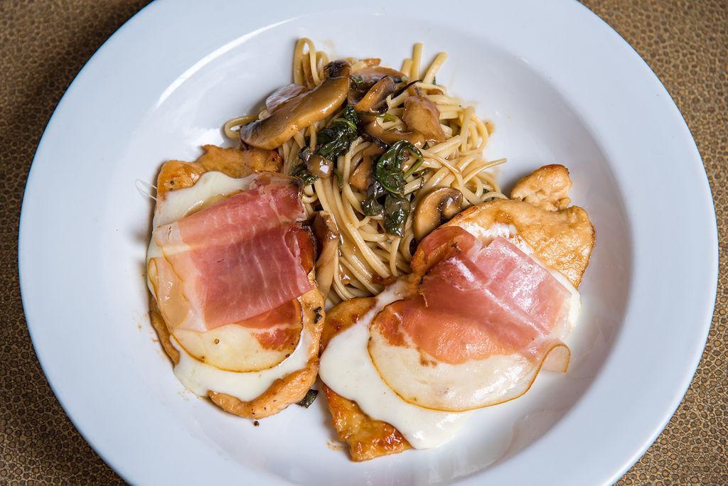 Chicken Saltimbocca · Pan seared and topped with prosciutto, spinach and mozzarella, served over linguini in a sage mushroom sauce.