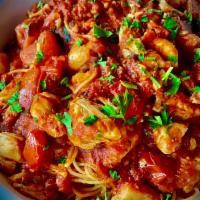 Capellini Positano · Fresh cherry tomatoes sauce marinara with garlic and jumbo lump crab meat over angel hair pa...