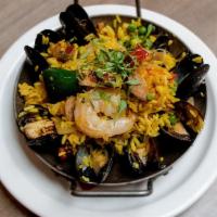 Paella · Mussels, shrimp, chicken, chorizo, peas, peppers, onions, tomatoes and saffron rice.