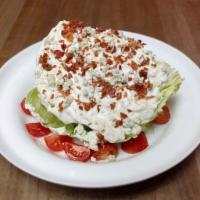 Iceberg Wedge Salad · Crispy serrano ham, tomatoes and blue cheese dressing.