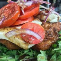 Chicken Milanese Dinner · Breast chicken lightly pan-fried, served over arugula with chopped tomatoes and red onion, d...