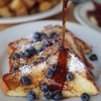 Challah French Toast · Thick sliced challah bread dipped in our vanilla, cinnamon, egg, batter. Topped with whipped...