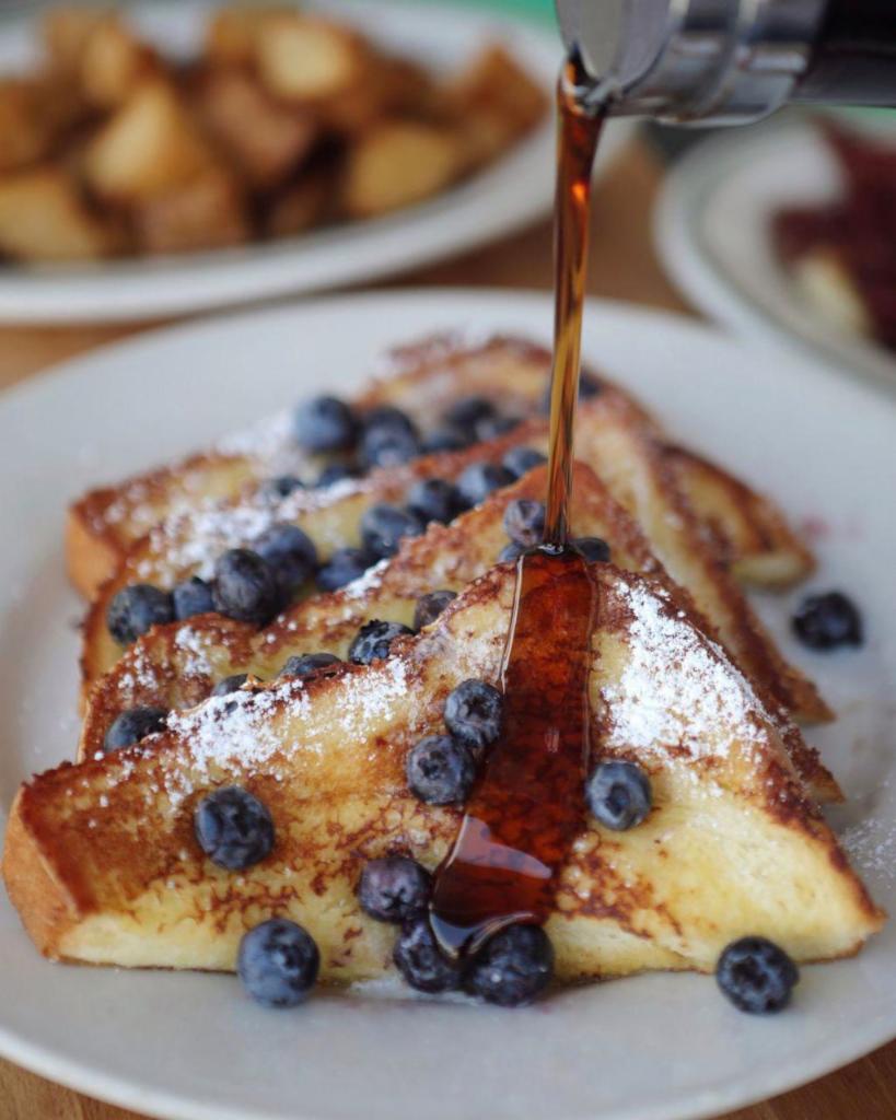 Challah French Toast · Thick sliced challah bread dipped in our vanilla, cinnamon, egg, batter. Topped with whipped butter and powdered sugar on top.
