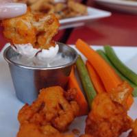 Buffalo Cauliflower · Lightly fried florets tossed in Buffalo our sauce, blue cheese dressing.