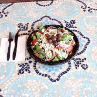 Greek Salad · Romaine lettuce, tomato, cucumber, black olives, red onion, feta cheese, Greek dressing.