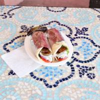 Gyro Sandwich · Gyroso wrapped inside two small pitas with onion lettuce and yogurt cucumber spread.