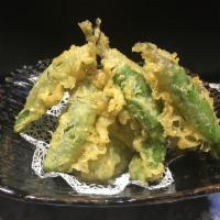 Shishito Peppers · 10 pieces Japanese shishito peppers. Lightly fried, served with ponzu sauce.
