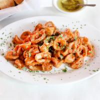 Calamari Toscana · Fried calamari in a cherry peppers spicy sauce.