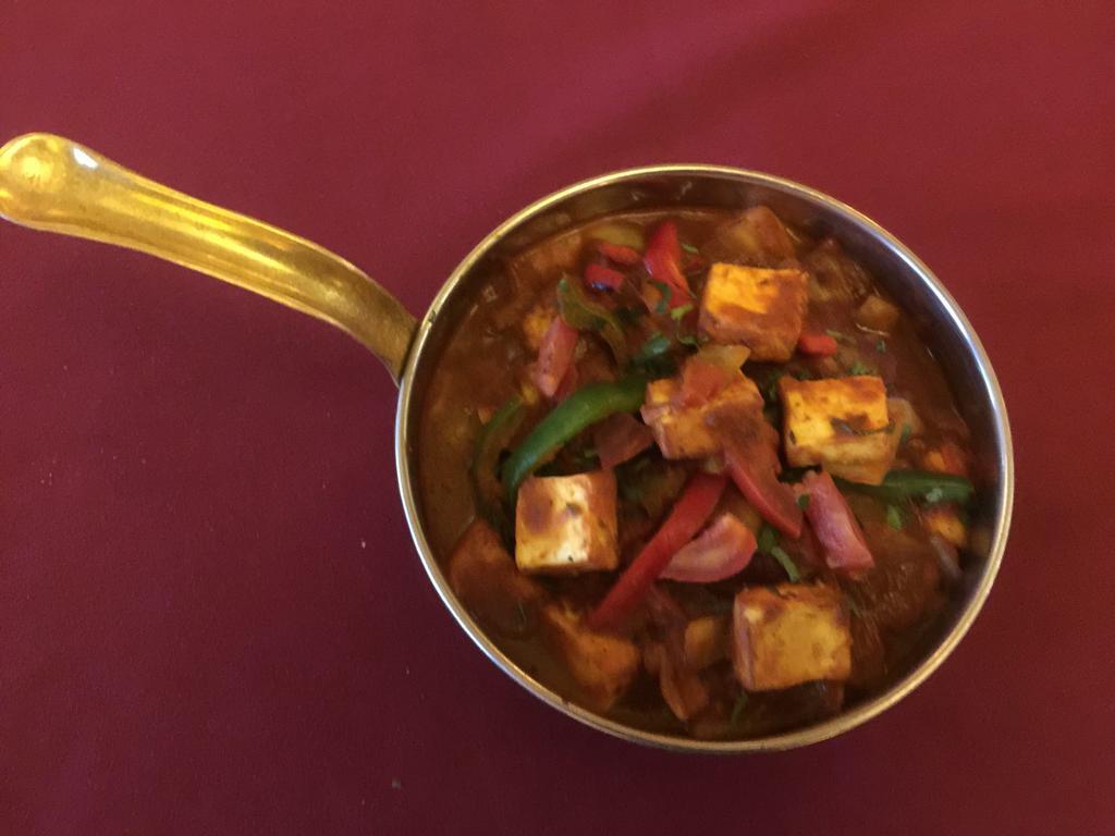 Kadai Paneer- ( gluten free) · Homemade cheese cooked with bell pepper, tomatoes, onion, ginger and garlic in a special blend of spices.  Served with homemade chutney and pickle.
