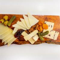 Just the Cheeses! Board · Brie, Asiago, manchego, and cranberry cheddar cheeses. Served with Pita and Olives