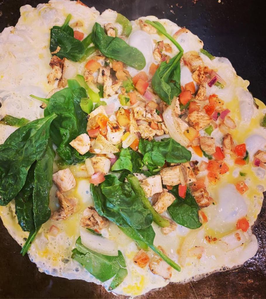 Open Faced Hearty Bowl · A whole wheat tortilla open faced and filled with 4 fresh egg whites, bell pepper, onions, zucchini, spinach, mushrooms, grilled chicken, medium salsa & cheese.