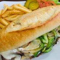 Philly Cheesesteak Deluxe · Onions, peppers and melted American cheese. Served with lettuce, tomatoes and fries.