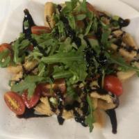 Fried Calamari Balsamico · Calamari tossed in balsamic reduction topped with cherry tomatoes, chopped scallions and aru...