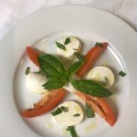 Caprese Salad · Fresh mozzarella cheese, tomatoes, balsamic, olive oil and basil.