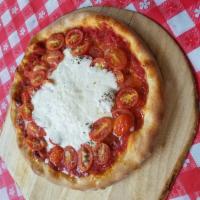 Burrata Pizza · Comes with cherry tomatoes, burrata cheese and crushed tomatoes.