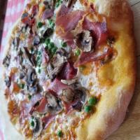 Carbonara Pizza · Comes with vodka sauce, mushrooms, peas, prosciutto and fresh mozzarella.