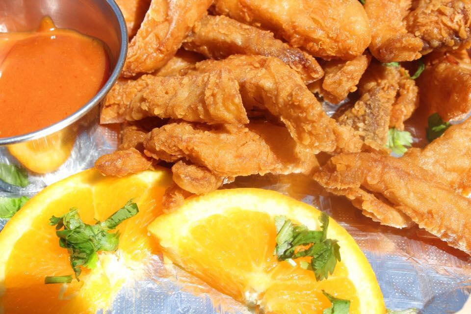 Chicharron de Pescado · Bite-size fried breaded fish. Served with your choice of tartar or chipotle sauce and fresh salad.