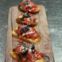 Bruschetta · Crostini rounds topped with our tomato bruschetta mixture, (Tomatoes, onions, 