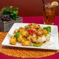 21. Golden Tofu Shrimp · Deep-fried tofu stir-fried with shrimp, garlic, bell pepper and onion served on a bed of cri...