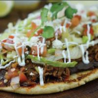 Tostadas · 2 fried tostada tortillas topped with your choice of meat; comes with lettuce, sour cream, p...