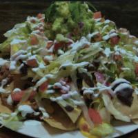Nachos · Your choice of meat topped with cheese, beans, lettuce, sour ram, and pico d Gallo served on...