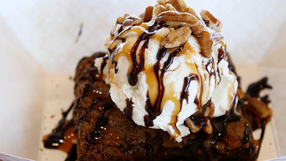 Warm Fudge Brownie Sundae · Warmed fudge brownie with premium vanilla bean ice cream, topped with caramel and chocolate sauces and pecans
