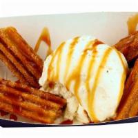 Caramel Churros · Crispy fried caramel filled churros tossed in cinnamon sugar topped with premium Vanilla bea...