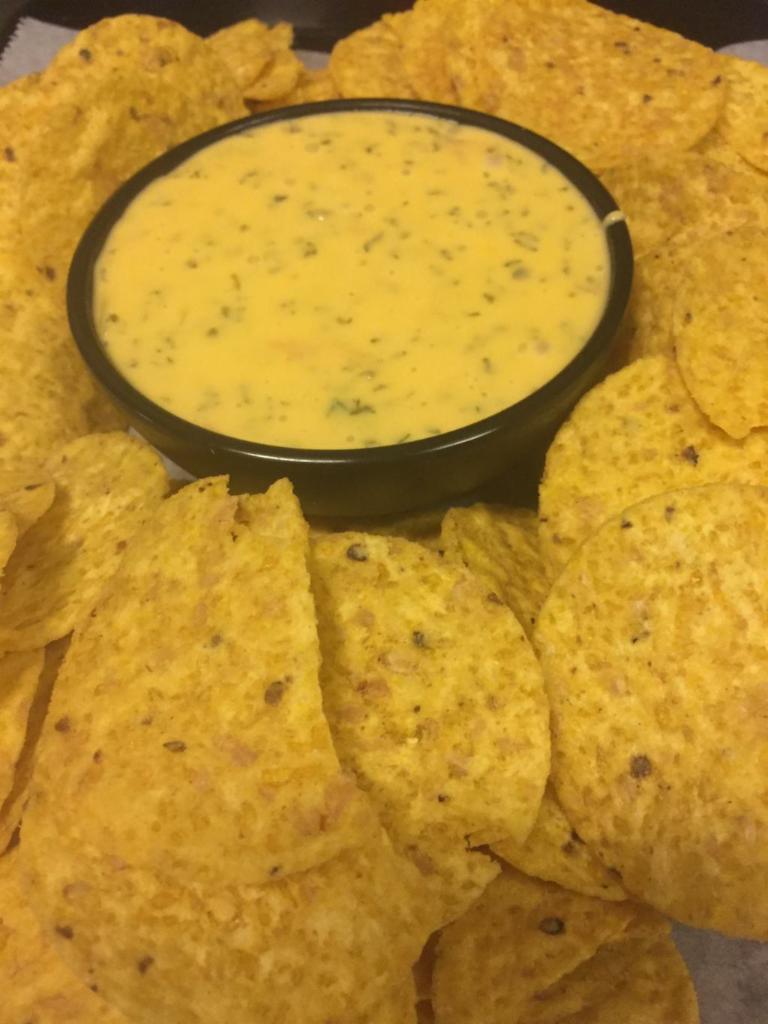 Chili con Queso · Homemade cheese dip blended with tomatoes, onions, parsley and jalapenos.