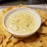 Spinach and Artichoke Dip · A blend of Parmesan and cream cheese, herbs, spinach, artichoke hearts, served with tortilla...